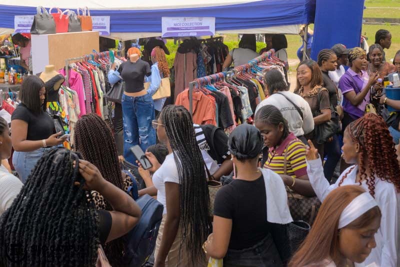 A visitor browsing vendor stalls at a Silo exhibition